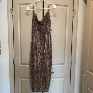 Black and gold shiny snake print dress with small slit and cowlneck